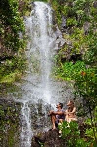 Couple relaxing at a waterfall