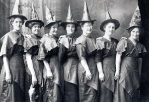 A 'coven of witches' line up for a Halloween portrait dressed in festive witch's hats and improvised costumes, ca.1910, United States. (Photo by Transcendental Graphics/Getty Images)